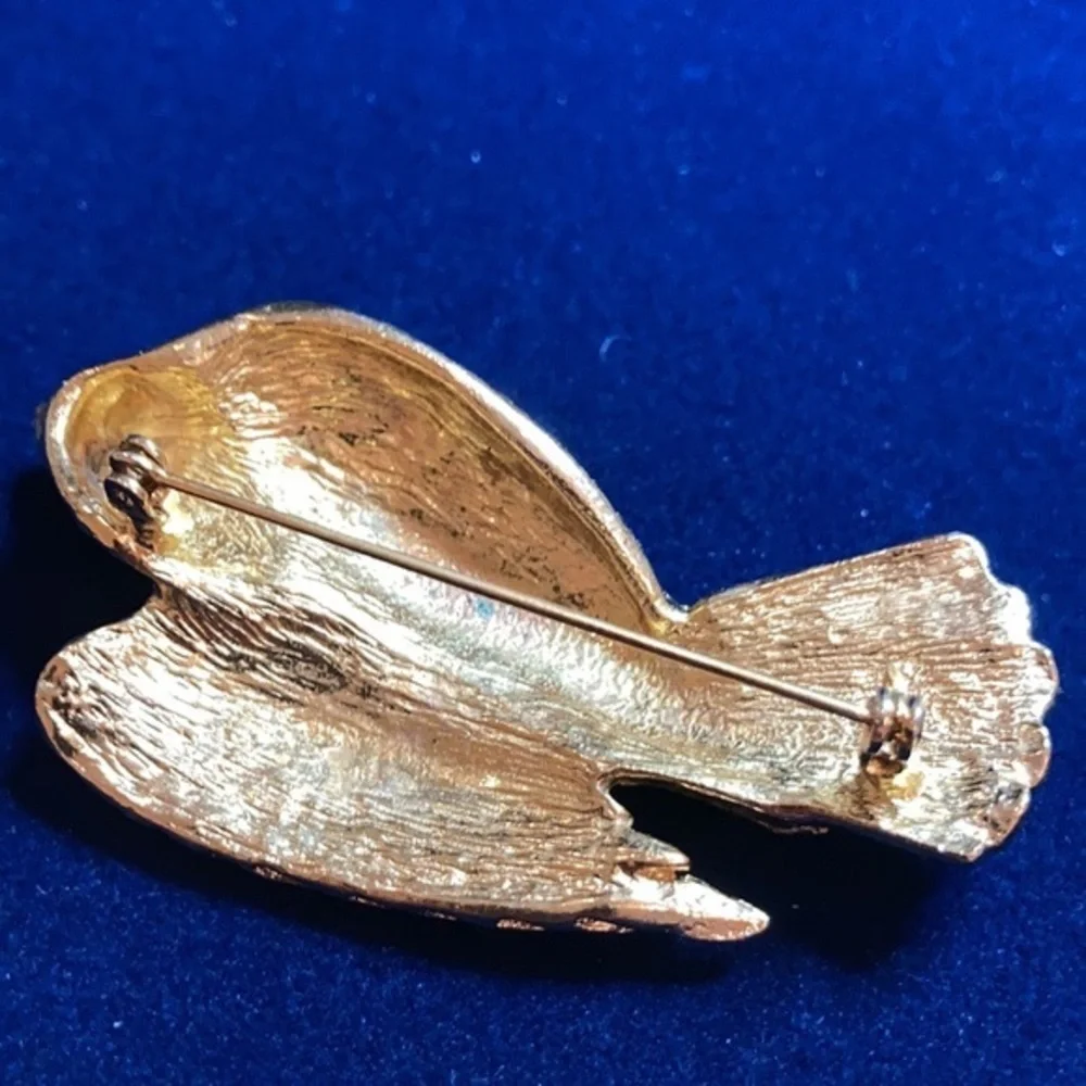 Vintage ‘60s gold tone Nesting eagle with red rhinestones